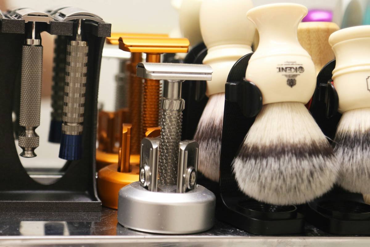 Premium shaving brush and shaving accessories arranged on marble surface