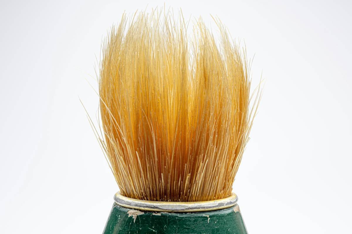 Close-up of classic shaving brushes bristles loading soap from puck