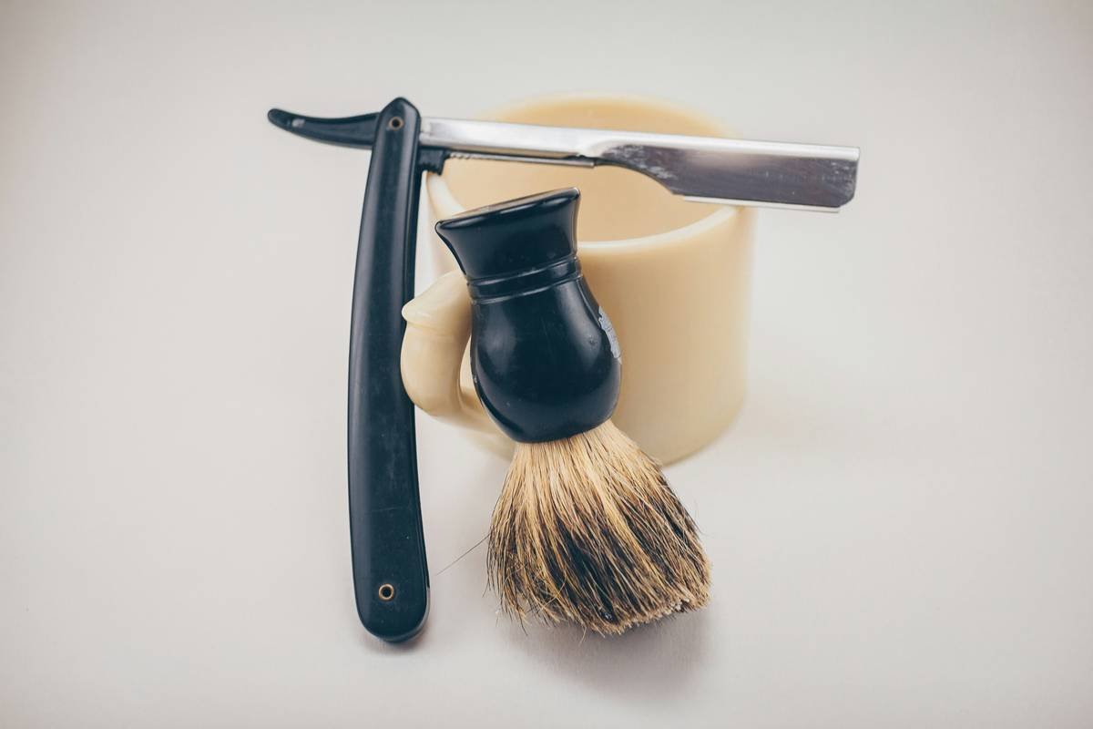 Man using shaving brushes for men to apply lather before wet shave